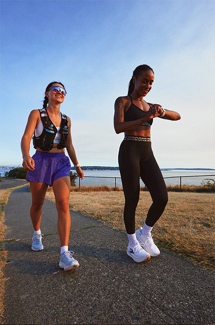 two female runners enjoying a run in Brooks shoes by the water